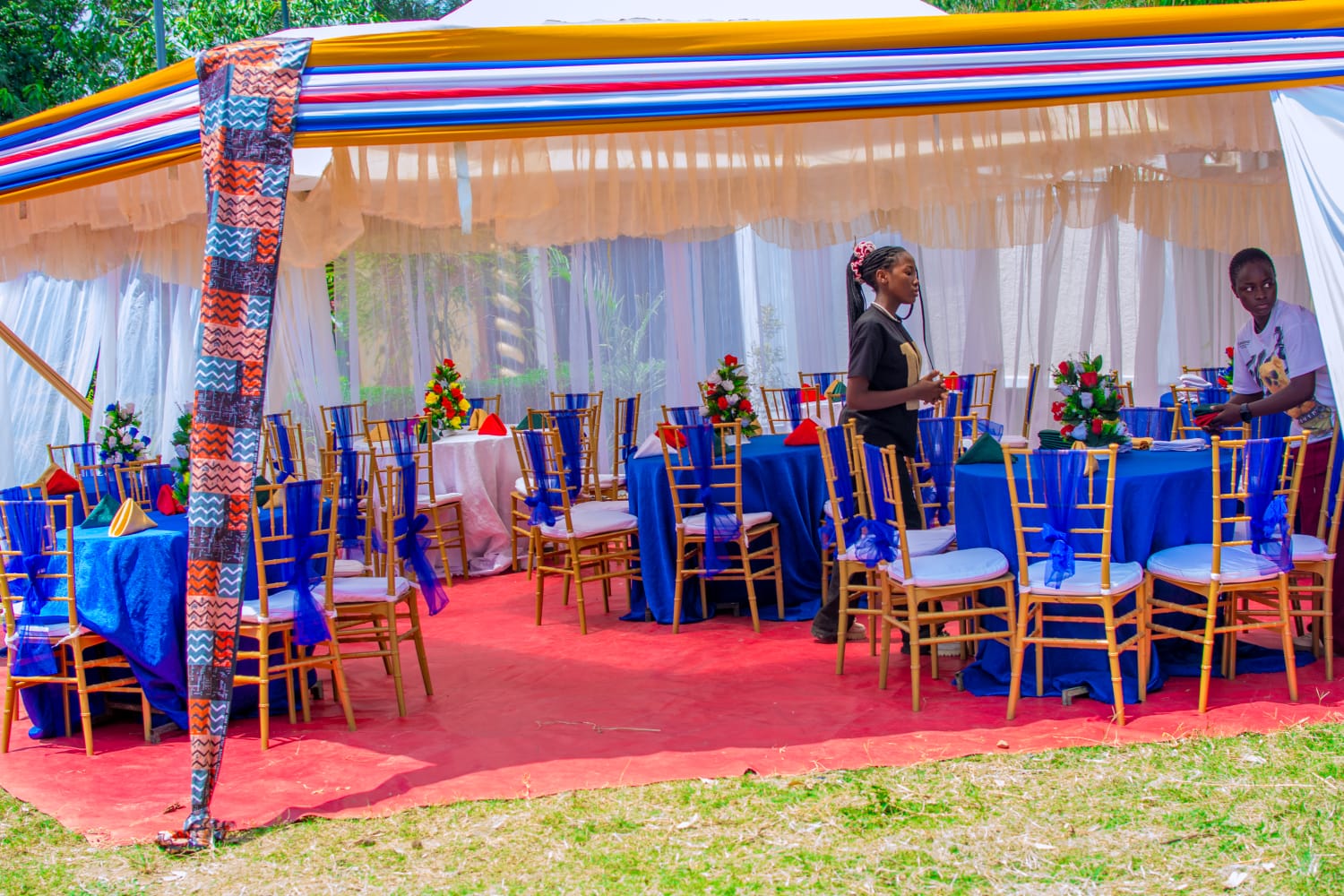 Gazebo with royal blue tables and gold chiavari chairs