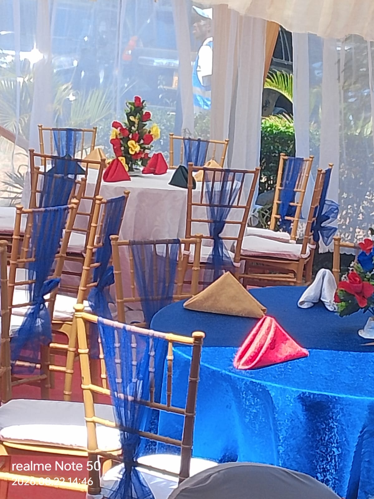 Royal blue tables with gold chiavari chairs