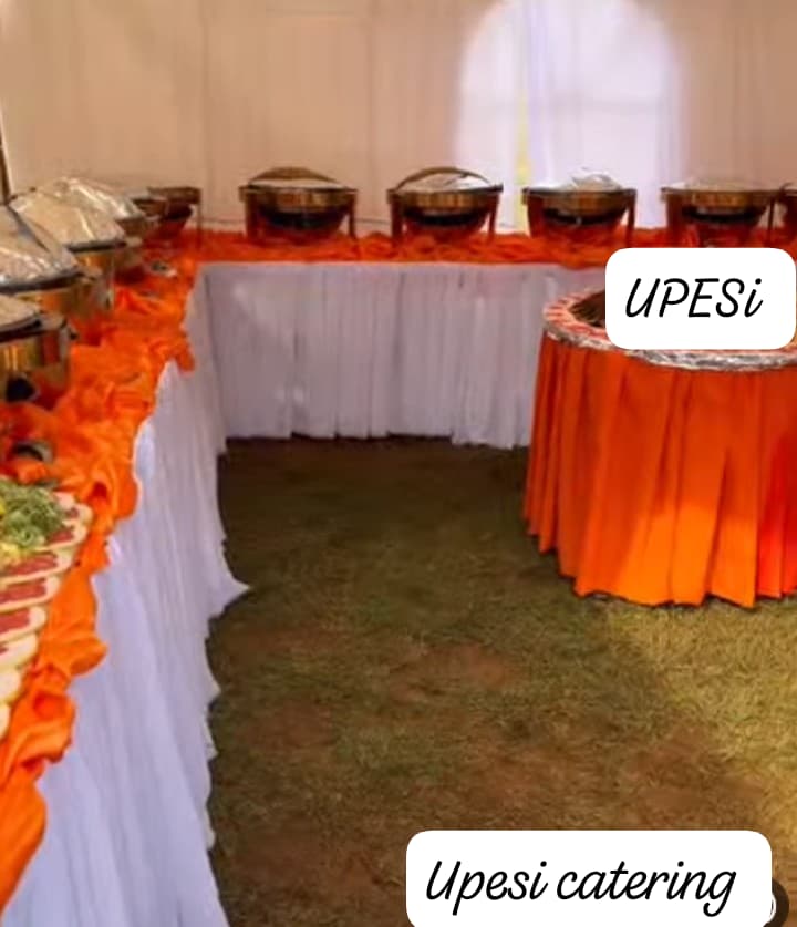 Orange draped buffet with chafing dishes