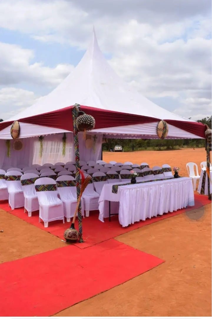 White and maroon tent with traditional decor
