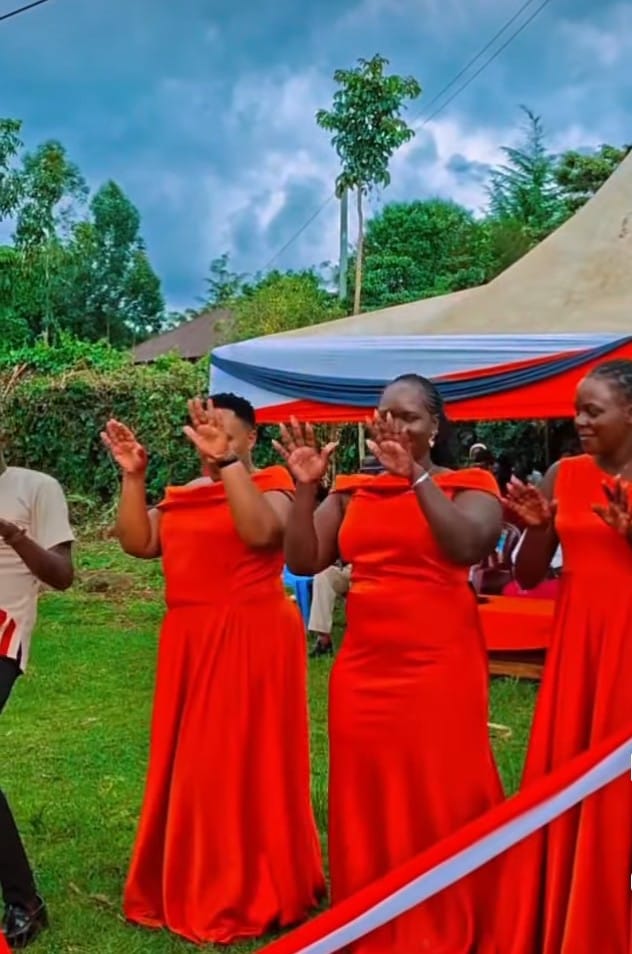 Guests in red dresses under the tent
