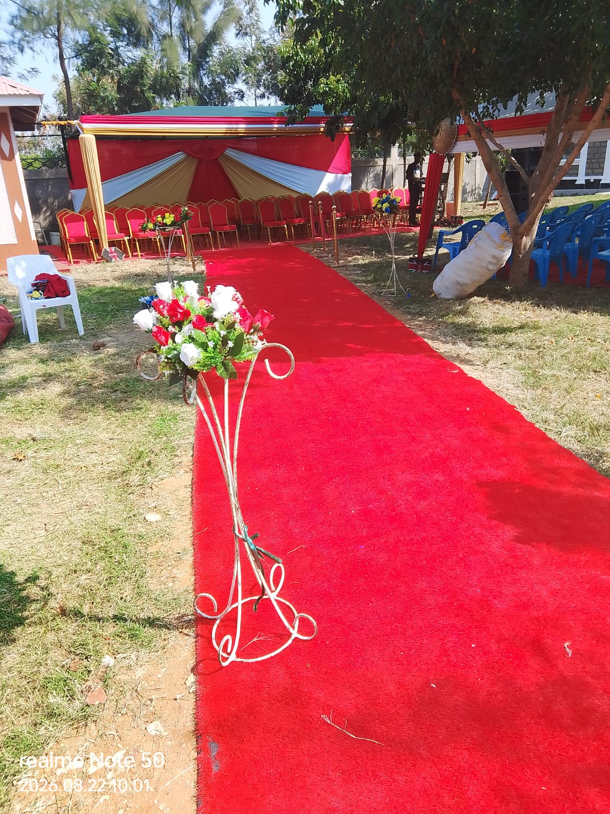 Red carpet aisle with floral stands
