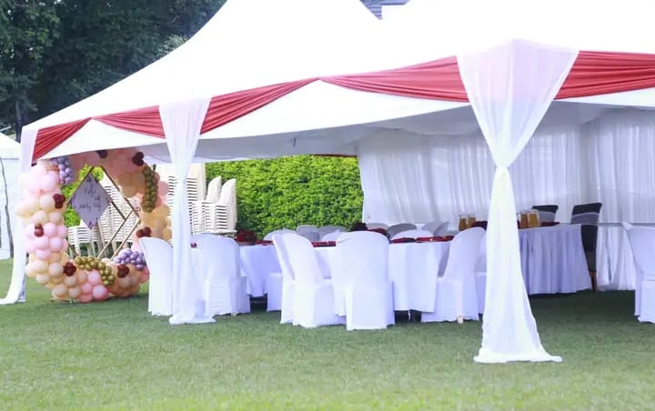 White and red tent with balloon arch entrance