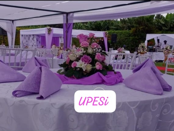 Purple reception table with rose centerpiece